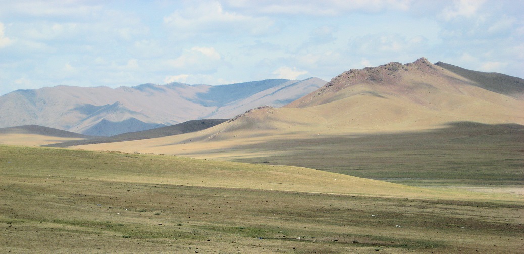  Bronze vessels from Steppe Eurasia used for sausage production and blood storage, against a backdrop of the Mongolian Steppe landscape.